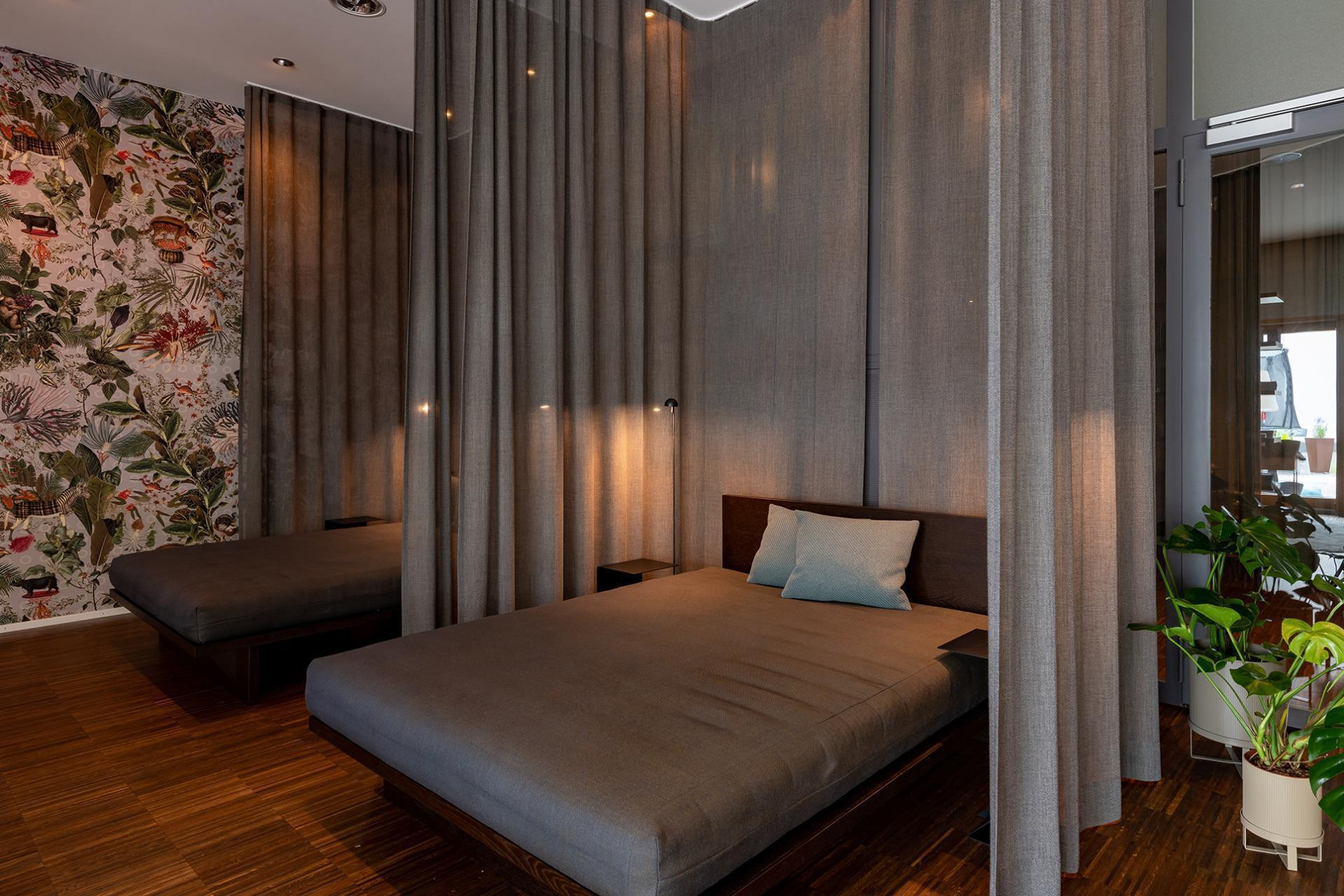 Ruhebetten mit Vorhängen als Trenner mit Kissen und Pflanzen