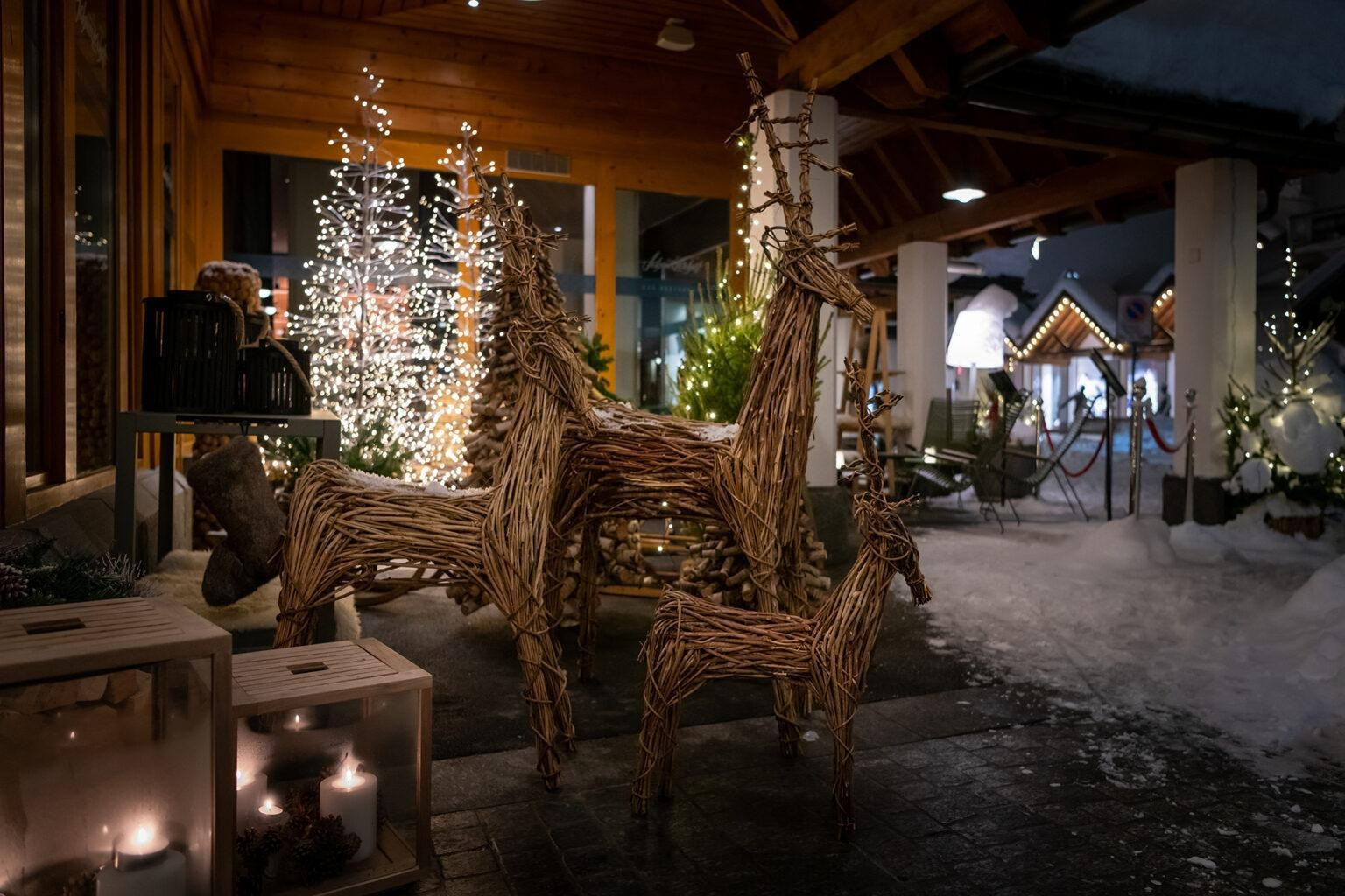 Dekorierter Aussenbereich des Hotels mit Weinachlicher Stimmung, Rehfiguren aus Holz, Kerzen und Weinachtslichter