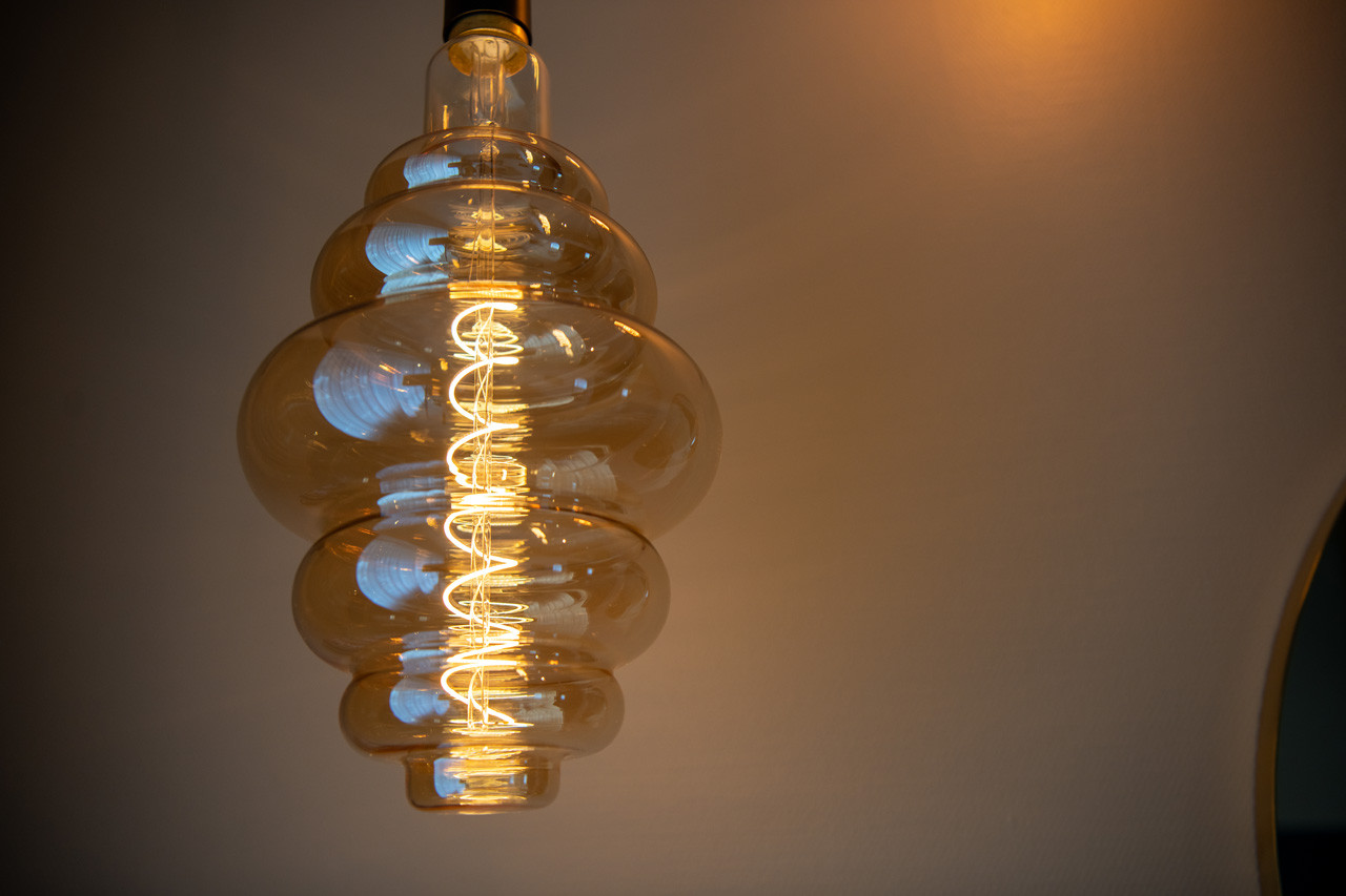Detailaufnahme einer dekorativen Glühbirnenleuchte im Nostalchic Belle Étage Zimmer.